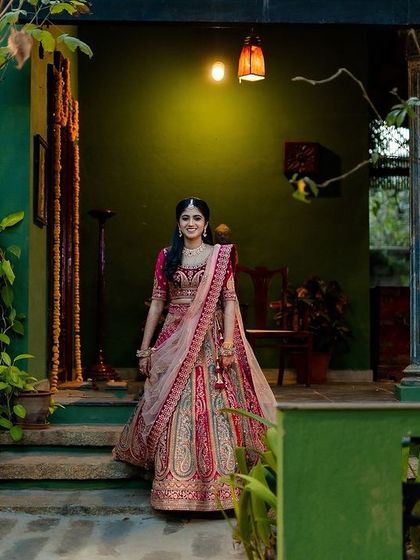 The bride makes her entrance at a beautiful, rustic-chic venue. The warm lighting and lush greenery create a welcoming and elegant atmosphere.
