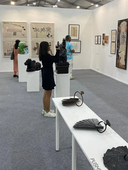 A visitor photographing a sculpture by Gopinath S.