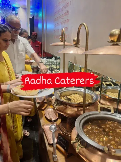 Guests lining up at the buffet during a birthday celebration. You can see the Hakka noodles and a Manchurian gravy ready to be served from our copper wares.