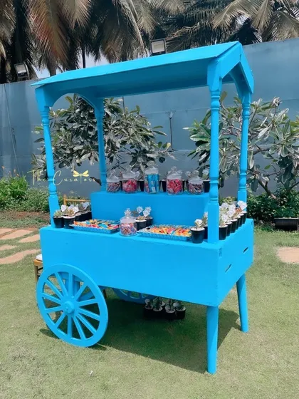 A whimsical candy cart, painted in the party's signature blue. It was filled with colorful treats and sweets, becoming a favorite spot for the little guests.