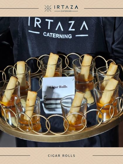 Crispy cigar rolls served elegantly in individual glasses with a sweet chili dipping sauce. This presentation is not only stylish but also makes it easy for guests to enjoy while socializing.