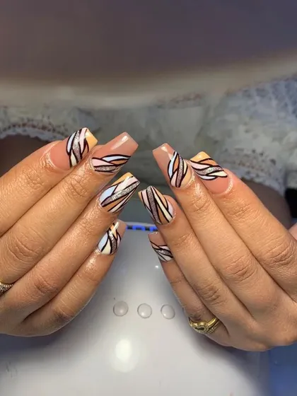 A stylish set of square nails with a nude base and an abstract pattern of wavy lines in neutral colors.