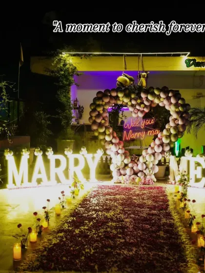 A moment to cherish forever. The warm glow of the marquee letters and the candlelit rose petal aisle created an incredibly romantic atmosphere for this heartfelt proposal.