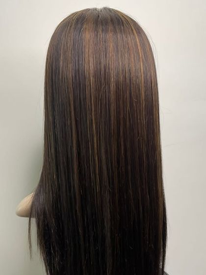 The back view of a mono base hairpiece with subtle highlights. This shows the smooth texture and expert coloring that we can achieve to match your desired style.