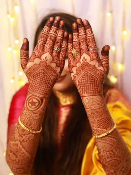 A playful pose showing off a full bridal set that includes personalized superhero logos.