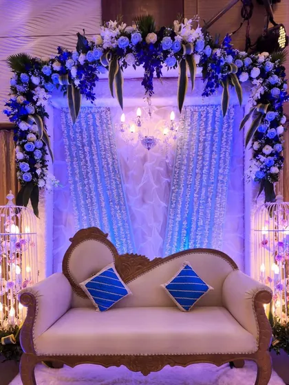 This couple's seating area was the centerpiece of a blue and silver themed Sangeet. The floral arch, shimmering curtains, and birdcage props filled with lights create a beautiful and unique backdrop.