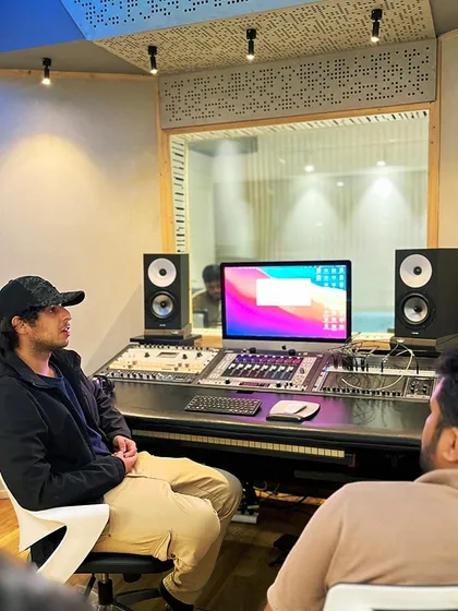 A mentor and student discussing a mix in the control room. Our courses are interactive, providing real-time feedback and guidance.