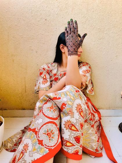 A client casually showing off her beautifully stained back-hand design. The dark, even color is the result of quality henna and care.