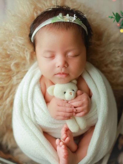 Another angle of this sweet baby girl, showing her peaceful sleep while holding her teddy. The composition draws your eye to her face and tiny hands.