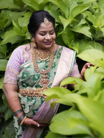 Another beautiful angle of Pavithra's baby shower look, showcasing the intricate patterns and rich texture of the handwoven silk.