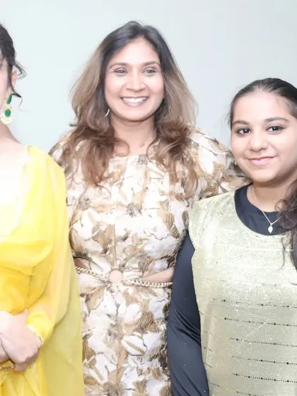 A happy moment with my daughter and a guest at the MIGA Fashion Show. My family's support has been my biggest strength throughout my journey.