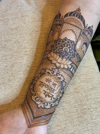 A beautiful back-of-the-arm design featuring the Taj Mahal, a lotus, and a personalized message in Bengali, showcasing my ability to create custom multilingual designs.