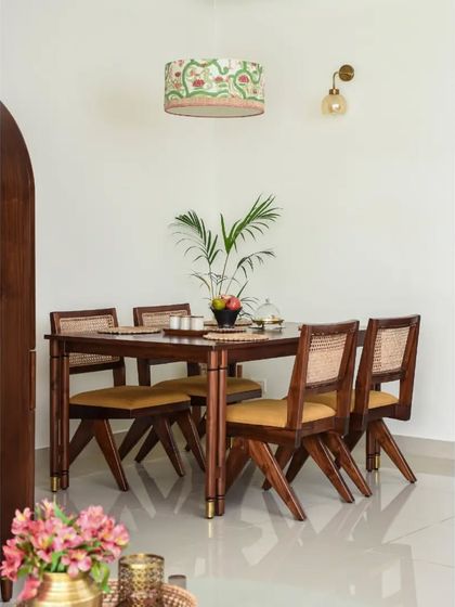 The Bagh collection, featuring a tall unit customized as a Pooja cupboard and a statement dining table with eight unconventional legs and brass accents. This shows how we can adapt our designs for different functional and aesthetic needs.
