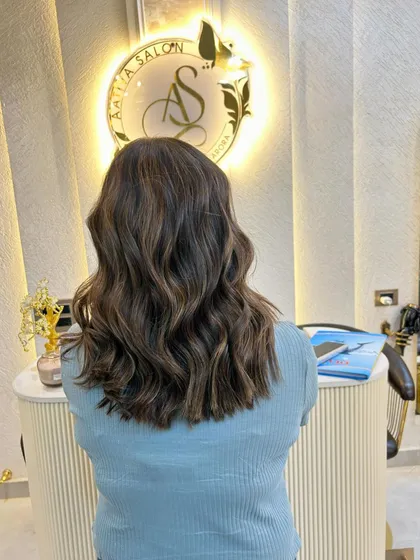 A beautiful shot of the caramel blond hair colour against our salon's stylish backdrop.