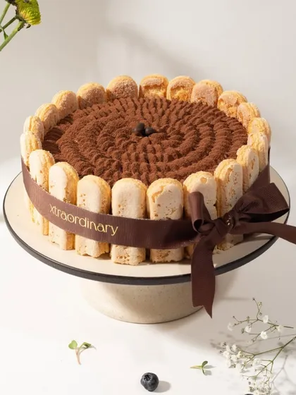 This is my take on a classic Tiramisu cake, with coffee-soaked ladyfingers, mascarpone cream, and a generous dusting of cocoa powder, all wrapped in our signature ribbon.