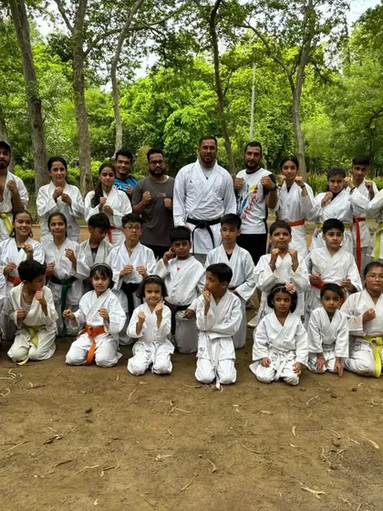 The full group of kids and adults who participated in our outdoor belt test. This is what our community looks like: all ages, training together.