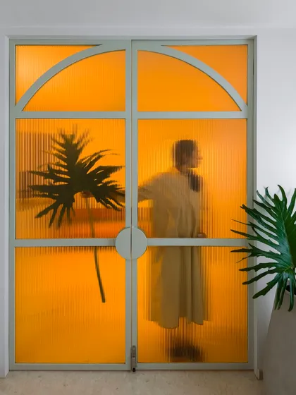 We believe a touch of the unexpected can transform a space. This bold, translucent yellow door is a perfect example, casting a warm, artistic glow and turning a simple entryway into a memorable design moment. It proves that even a single pop of color can shift the entire mood of a home.