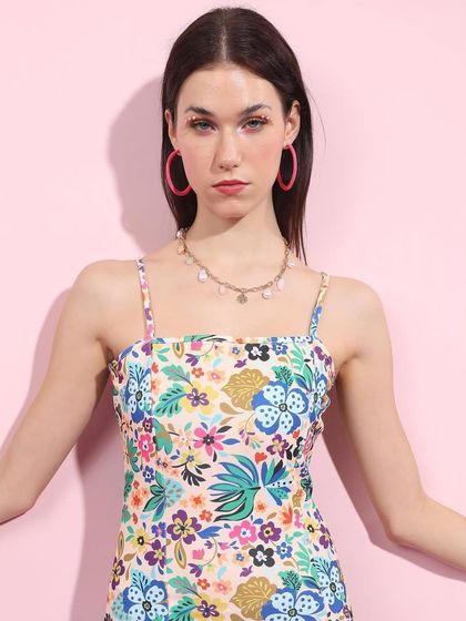 This floral dress brings a different texture to the Barbiecore theme. I styled it with bright pink hoop earrings to tie into the color palette and keep the look playful.