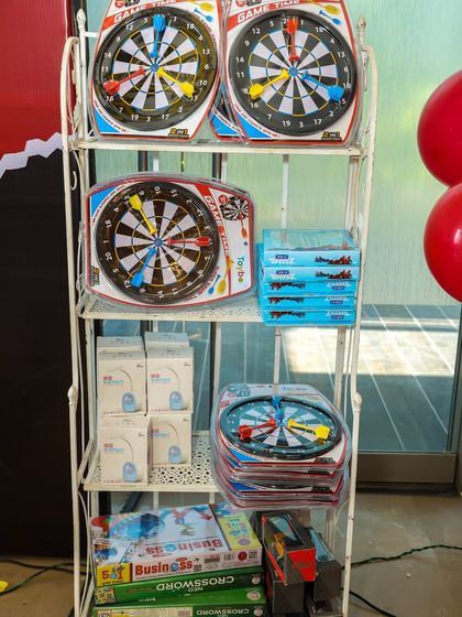 A selection of themed return gifts, including dart boards and other games, for the superhero party.