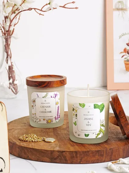 A duo of our frosted glass candles, featuring Lavender & Chamomile and Jasmine & Mint scents. The reusable Indian Rosewood lids add a touch of natural elegance to the minimalist design.