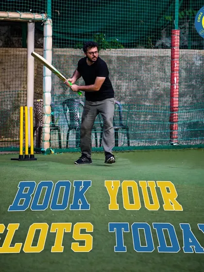 Ready to face the bowler? A player stands prepared for a game of box cricket on our versatile turf. This space is perfect for settling scores and creating memorable moments with your team.