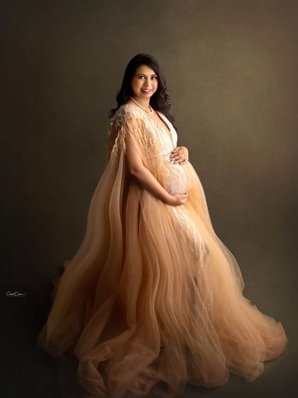 A full-length portrait showcasing the beautiful flow of this champagne-colored tulle gown.