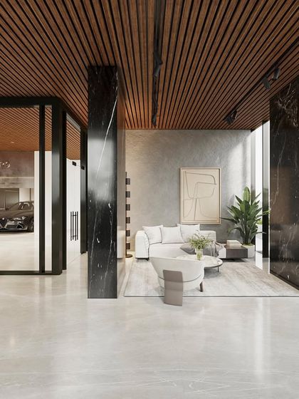 Another view of the lobby, showing the seamless connection between the entrance, the waiting area, and the private parking visible through a glass wall. The design uses a careful selection of materials to create a cohesive and luxurious narrative.