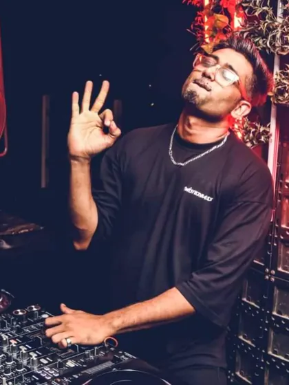 A classic DJ pose, feeling the vibe of the track before I mix it in. It is all about the feel and the flow.