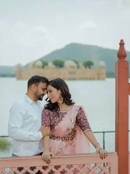 A classic romantic pose with Jal Mahal, the floating palace, creating a stunning and unique backdrop. This is a must-have shot for any pre-wedding shoot in Jaipur.