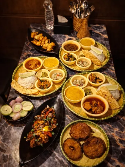 This is what we mean by 'barkat' or abundance. A table full of our thalis and starters, ready for friends and family to share. You can see our Assamese thalis, pork dishes, and fried starters, a true feast from the Northeast.