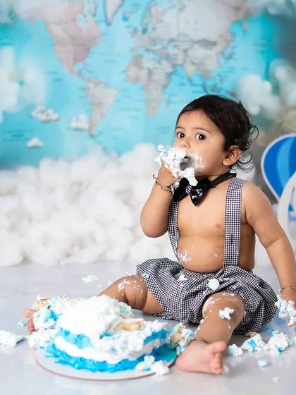 A close-up on the action. We focus on your baby's delighted expression as they explore the texture and taste of their cake.