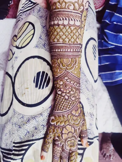 A single arm is shown with a detailed design that combines geometric bands with softer, floral patterns.