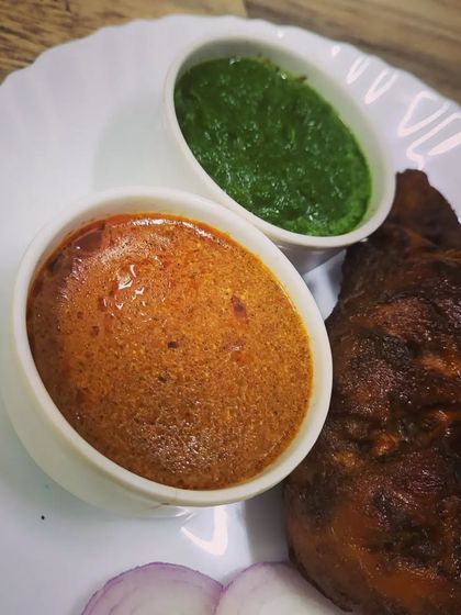 The delicious dips I serve with my Tandoori Chicken. One is a fresh and cooling green chutney, and the other is a rich and spicy gravy.