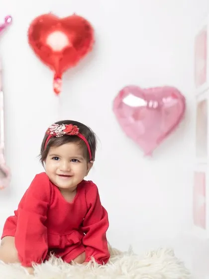 A lovely crawling pose, showing her happiness and excitement during her special birthday photoshoot.