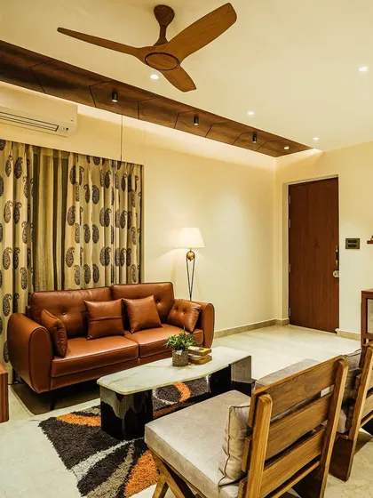 A detailed shot of the living room from image 51, showcasing the blend of modern furniture and traditional Indian art.