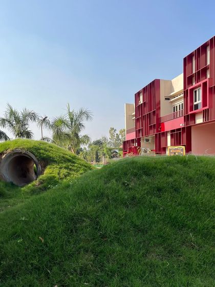 We believe play is a huge part of learning. At the SMBV school, we designed the landscape with these grassy mounds and tunnels to create a natural, interactive play zone for the younger kids.