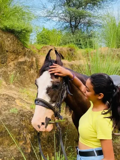 A moment of gentle affection between a rider and her horse. Our horses are not just for riding; they are companions that make the journey through the Aravallis special.
