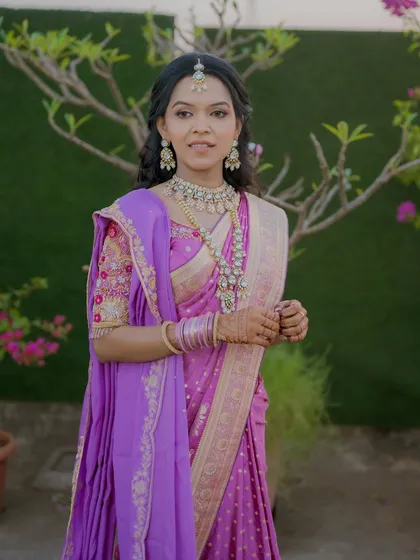 A confident and beautiful pose. The makeup is tailored to look perfect in outdoor lighting for her engagement photos.