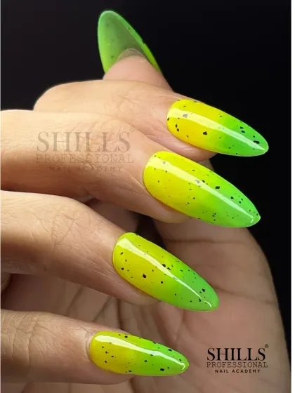 We love playing with bold colors. This design features a vibrant neon gradient from yellow to green, finished with a speckled eggshell top coat for a fun and edgy look on long almond-shaped extensions.