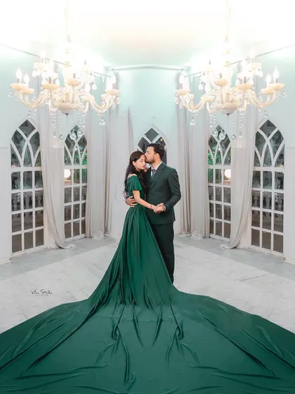 Let's create some drama and elegance. This shot from a studio session features a flowing gown and grand chandeliers, showing how we can craft a high-fashion, editorial look for your pre-wedding album.