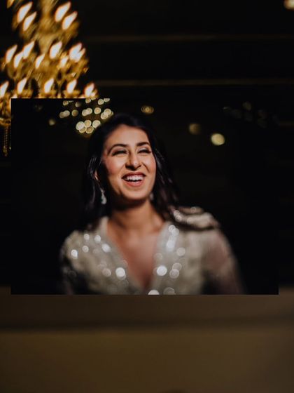 A candid moment of laughter from the bride during her portrait session, a beautiful contrast to the more posed shots.