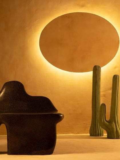 The Coral Seating bench set in a warm, earthy environment. The design is meant to feel both protective and welcoming, bringing a sense of calmness to any indoor or outdoor space.