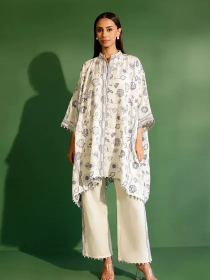 A full view of the Mulmul Wool Ashby Kurta in White. The asymmetrical hem and detailed embroidery offer a unique take on winter ethnic wear.