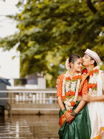 A sweet, candid moment between the newlyweds. The groom's gentle kiss on the bride's forehead is a simple gesture full of love.