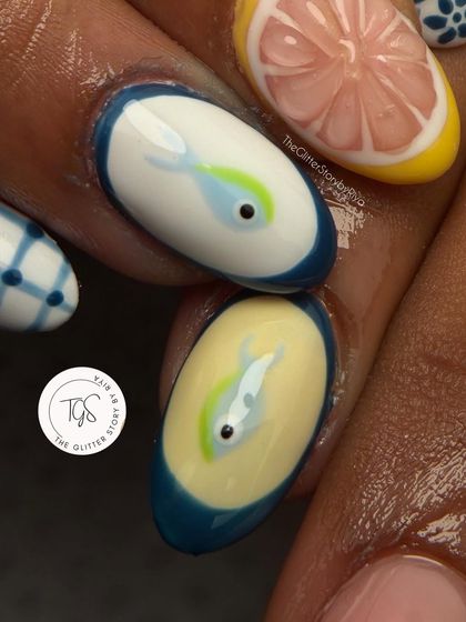 A close-up of a playful, summer-themed 3D nail set. This nail features a hand-painted fish with a 3D eye, showcasing intricate and fun design possibilities.