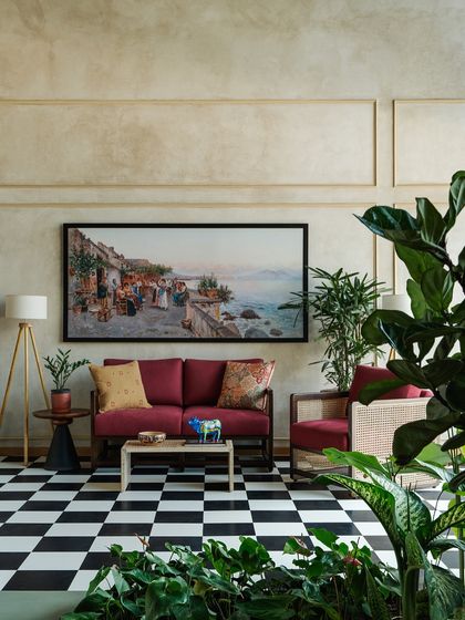 I used a classic black-and-white checkerboard floor in this area of the lounge to create a bold, graphic statement. This timeless pattern is paired with comfortable, contemporary furniture and vibrant artwork to create a sophisticated yet playful brand environment.