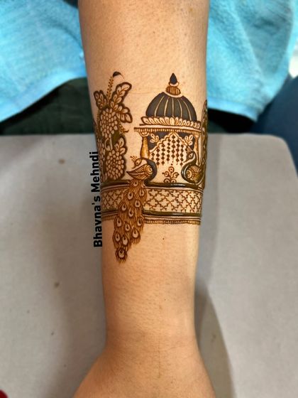 The start of a beautiful engagement design, showing the cuff with peacock and architectural motifs.