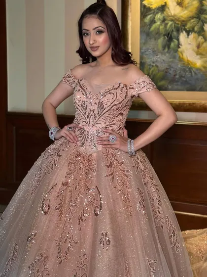 Another beautiful portrait in our rose gold ball gown, showcasing its versatility for photoshoots. The sparkling details and flattering silhouette ensure you look perfect from every angle.