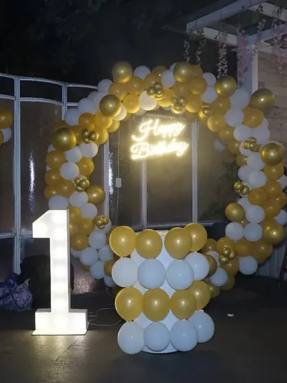 A wide angle of the birthday party decor, showing the "1" sign and balloon arch. This photo gives a great overview of the celebration's theme.