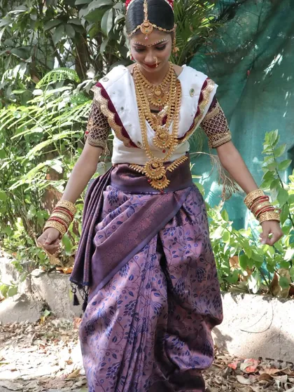 This is a traditional Kokani bridal look, which features a distinct style of saree draping and ornamentation. My courses cover the nuances of different regional bridal styles to make you a versatile makeup artist.